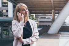 Vrouw belt met smartphone en ziet er opgelucht uit